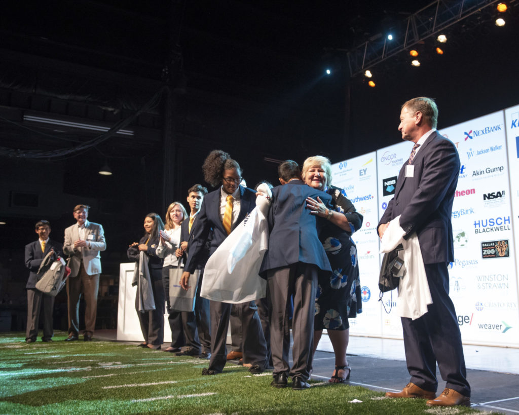 student hugging sponsor at draft day