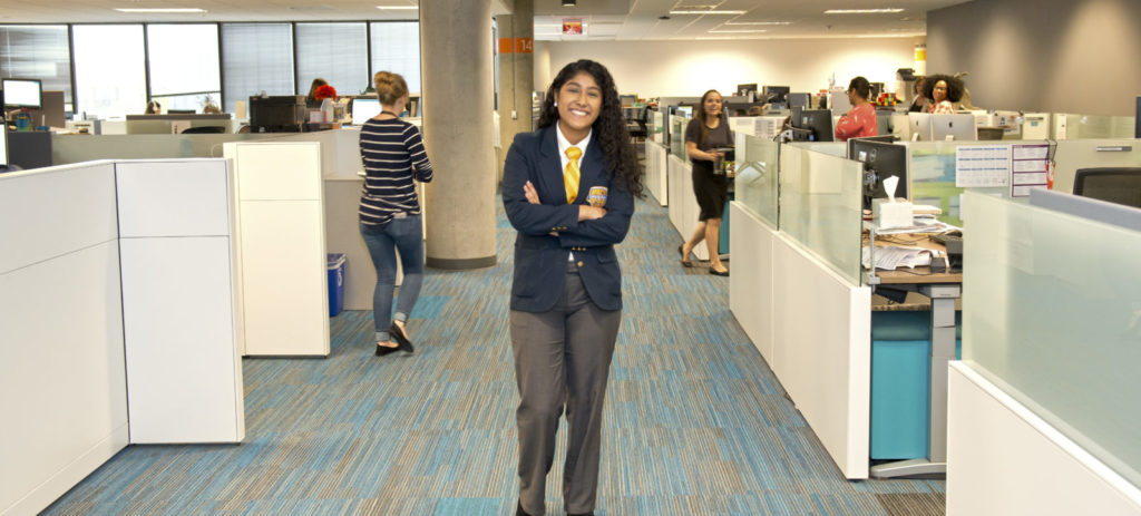 female student standing in work area